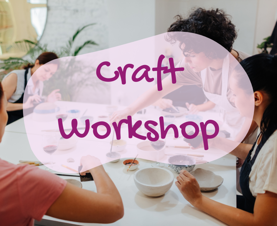 four people seated around a table engaged in a craft activity