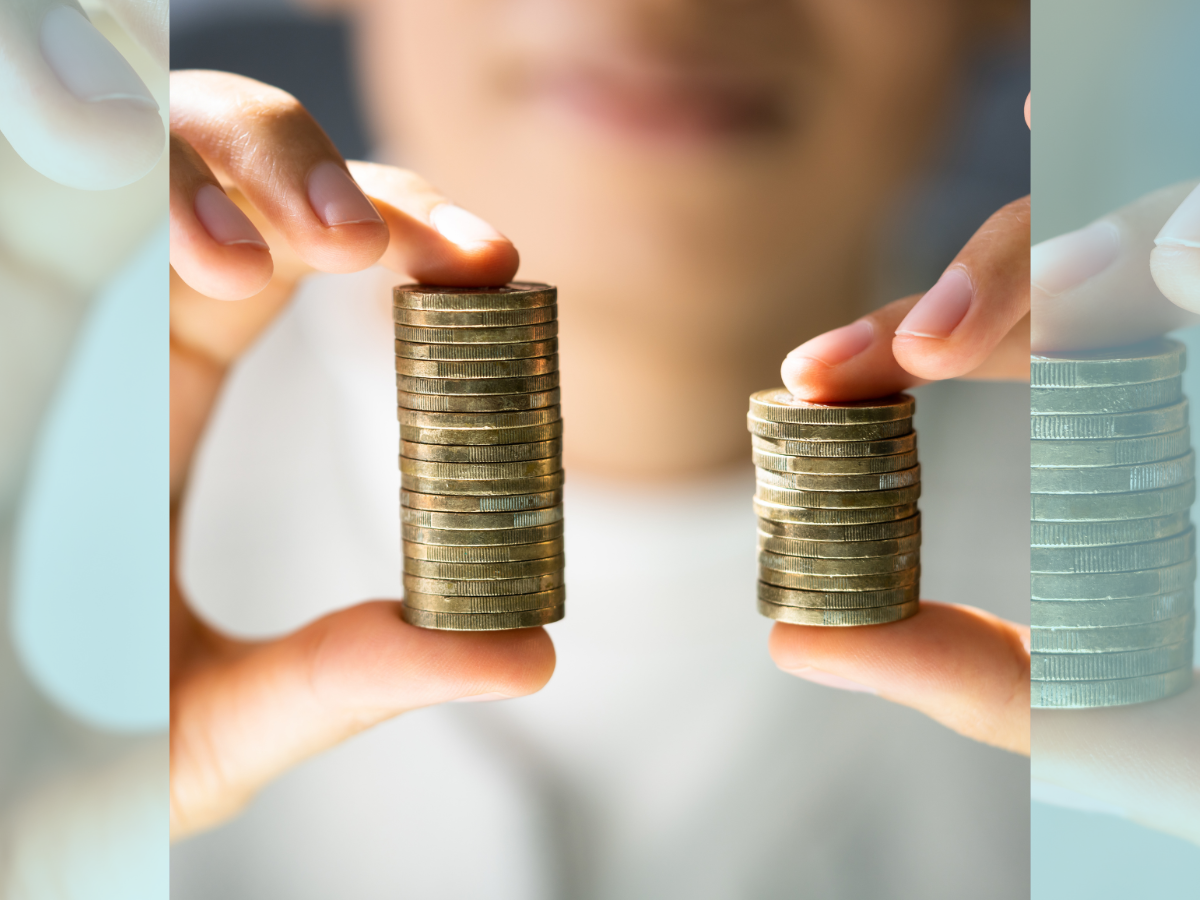 Fair pay represented by two hands holding two unequal coins stacks